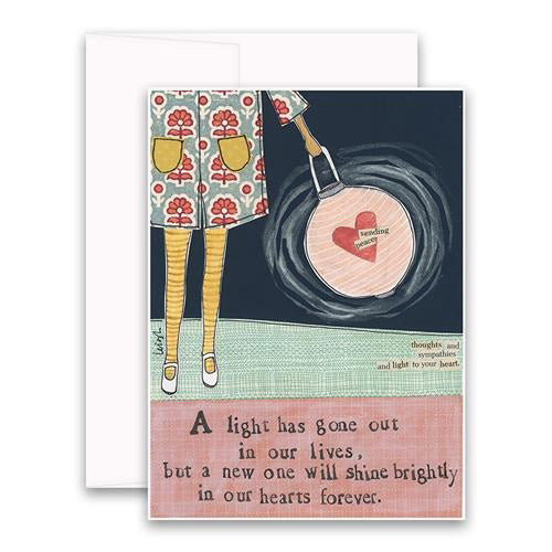 The CURLY GIRL DESIGN, INC - SHINE BRIGHTLY CARD is an illustrated sympathy card featuring a person holding a heart-shaped lantern with "Sending you love" written on it. The text reads: "A light has gone out in our lives, but a new one will shine brightly in our hearts forever, bringing us peace.