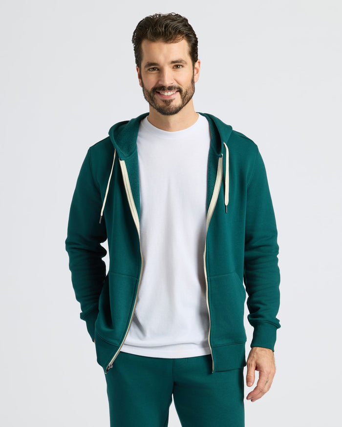 Man in Deep Emerald Full Zip Fleece Hoodie & Jogger 2-Pack, smiling.