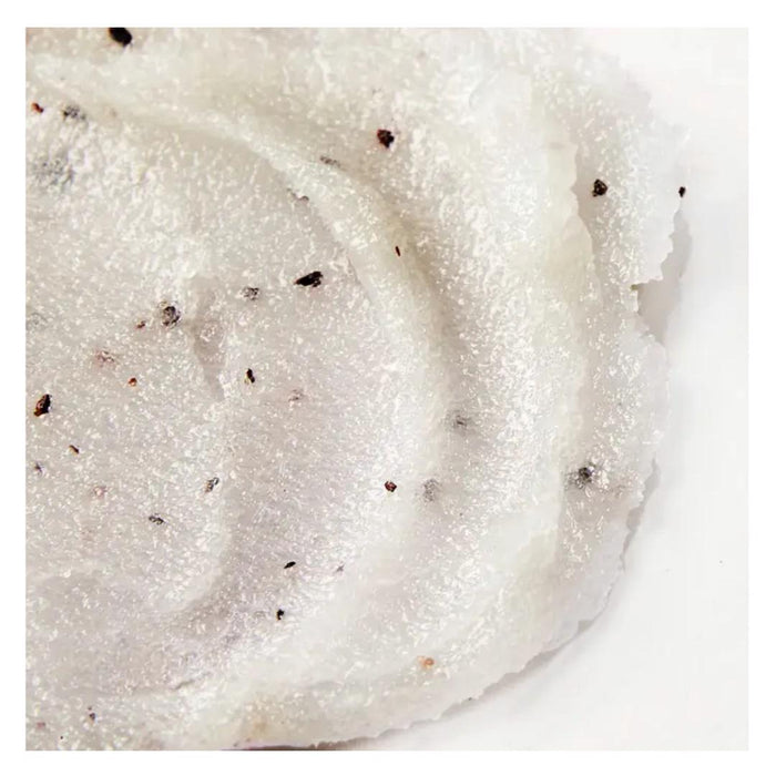 A clear glass jar with latch lid contains white ELEMIS – FRANGIPANI MONOI SALT GLOW by ELEMIS – STEINER. The label features red text, product name, 490g/17 US oz net weight—an indulgent exfoliating scrub for smooth, radiant skin.