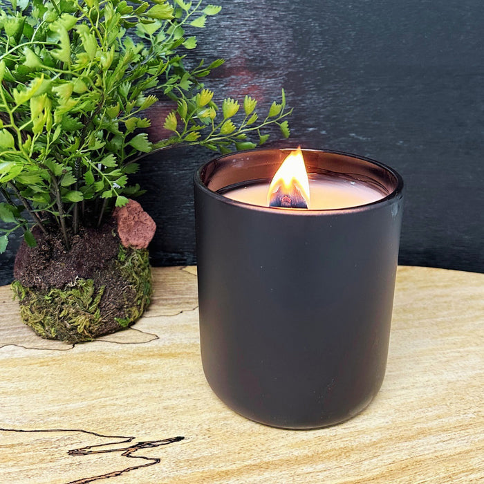 A sleek black box holds the FEARRINGTON SIGNATURE CANDLE by FEARRINGTON VILLAGE - HOME DECOR, with a white label and striped ribbon, featuring clary sage, white cedarwood, lavender, and mandarin scents.