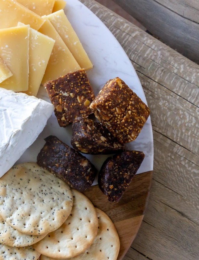 A brown and beige package labeled "FICHI - FIG AND ALMOND BITES" features three stacked bites. This vegan, gluten-free snack from FICHI contains only two ingredients, no added sugars, plus fiber and antioxidants.