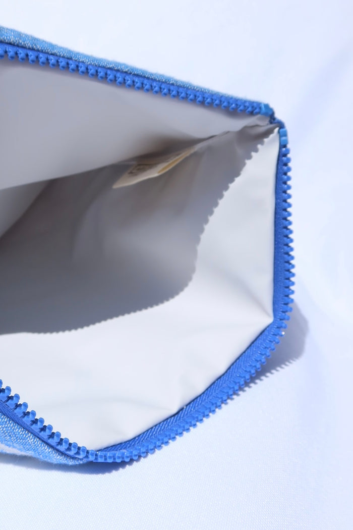 Close-up of a blue and white greek key pattern wet/dry clutch pag zipper pouch