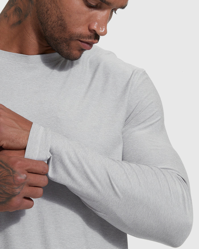 Man adjusts cuff of Heather Light Gray Active Long Sleeve Crew T-Shirt.