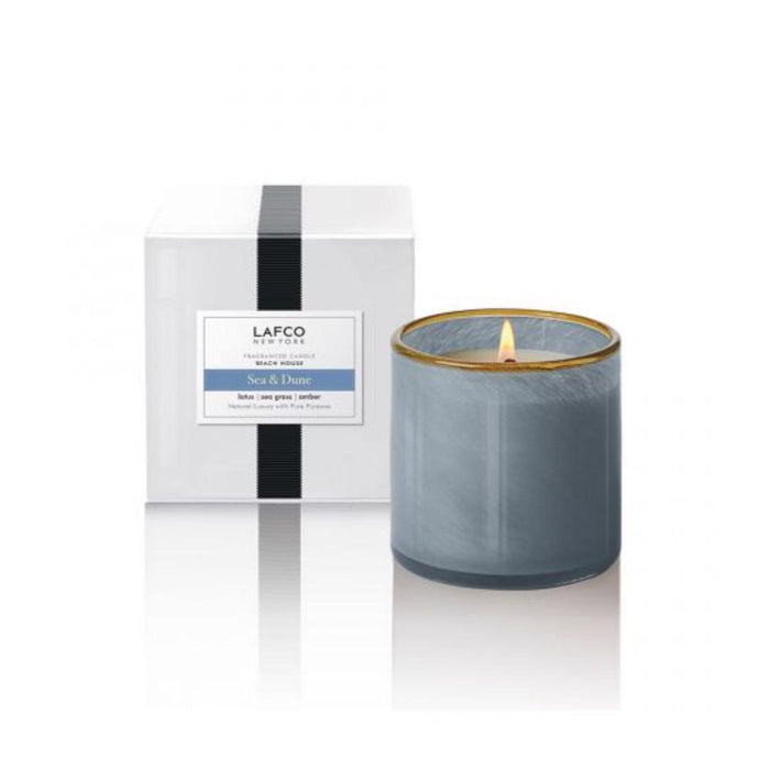 The LAFCO SEA DUNE Beach House 15oz candle is a cylindrical, gray container with a smooth, slightly shiny finish and a thin amber-colored rim, evoking serene beach house decor against a plain white background.