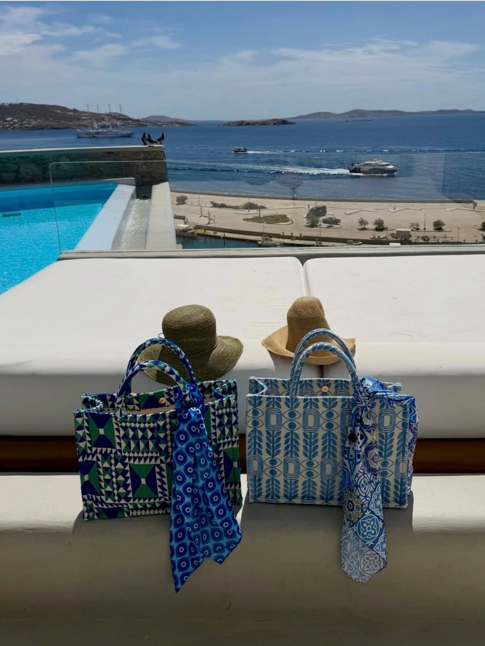 Blue woven evil eye print tote handbag on Emily in Paris (Mykonos) worn by Lily Collins from Aegean Essence