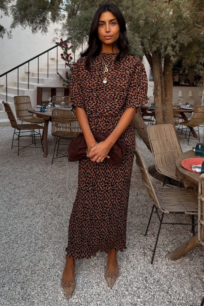 Lucia Leopard Tilly Dress Petite in iconic leopard print plisse, featuring an elasticated waist in an outdoor café.