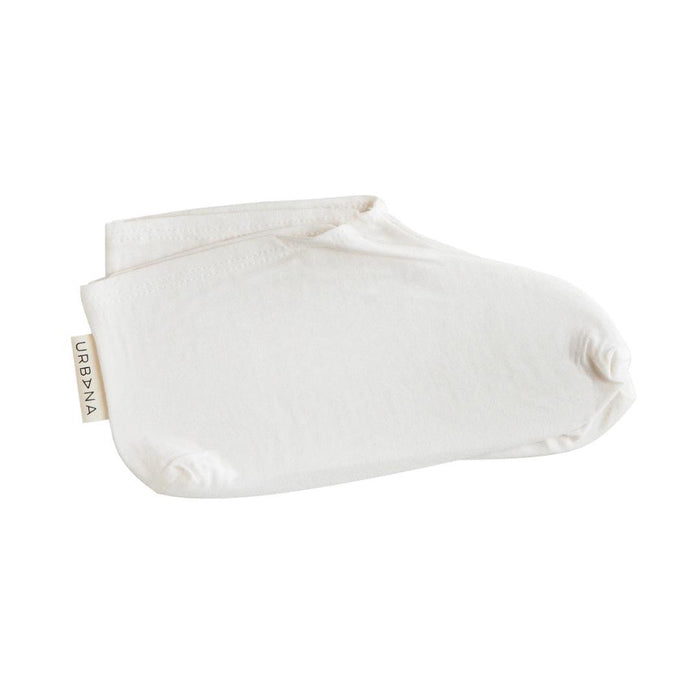 A pair of neatly folded white no-show socks featuring a small "URBANA" tag—ideal for use with EUROPEAN SOAPS, LLC MOISTURIZING BOOTIES to help create a relaxing at-home spa experience.