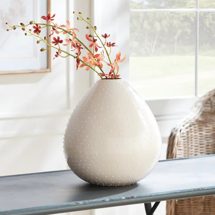 The NAPA HOME AND GARDEN - ORCHID STEM - ORANGE resembles a realistic botanical illustration with a thin green stem featuring multiple small, delicate pinkish-red flowers evenly spaced along the upper half, set against a plain white background, perfect for any home in a simple vase.