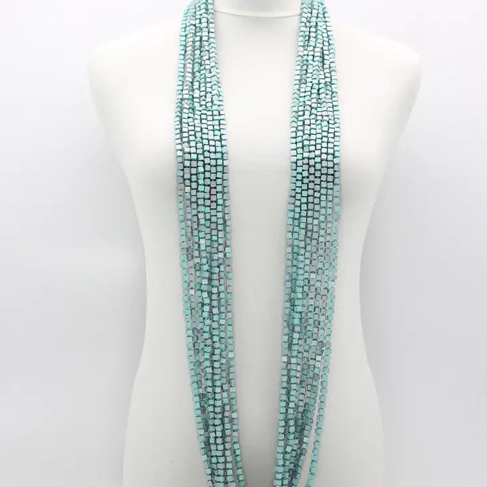 A mannequin displays the JIANHUI LONDON PASHMINA NECKLACE HAND PAINTED 10 STRAND, featuring vibrant, hand-painted wooden beads cascading elegantly around the neck.