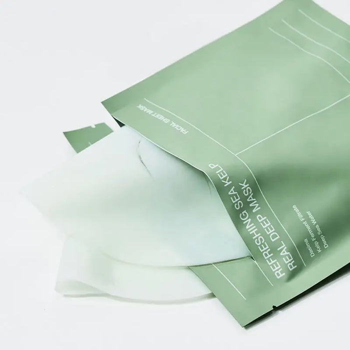 A person applies the BIODANCE - REFRESHING SEA KELP MASK by GLOWISS, partially removing it. Text reads: "3-4 hours. Infused with deep sea water, it absorbs without watery residue on the skin's surface and turns transparent.
