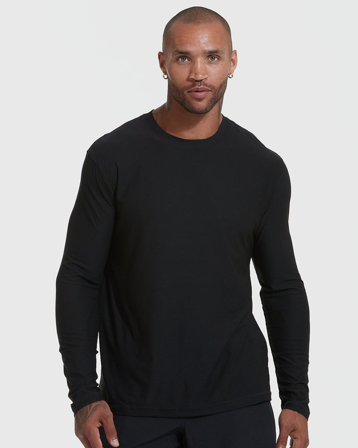 Man wearing Black Active Long Sleeve Crew Neck T-Shirt with earrings.