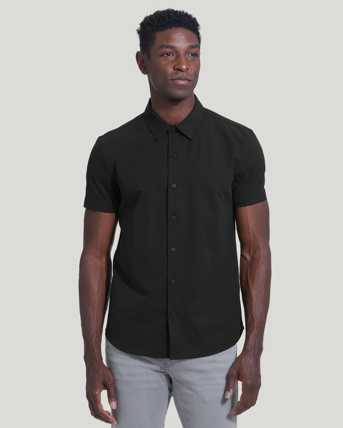 Man wearing Black Commuter Short Sleeve Shirt with light gray pants.