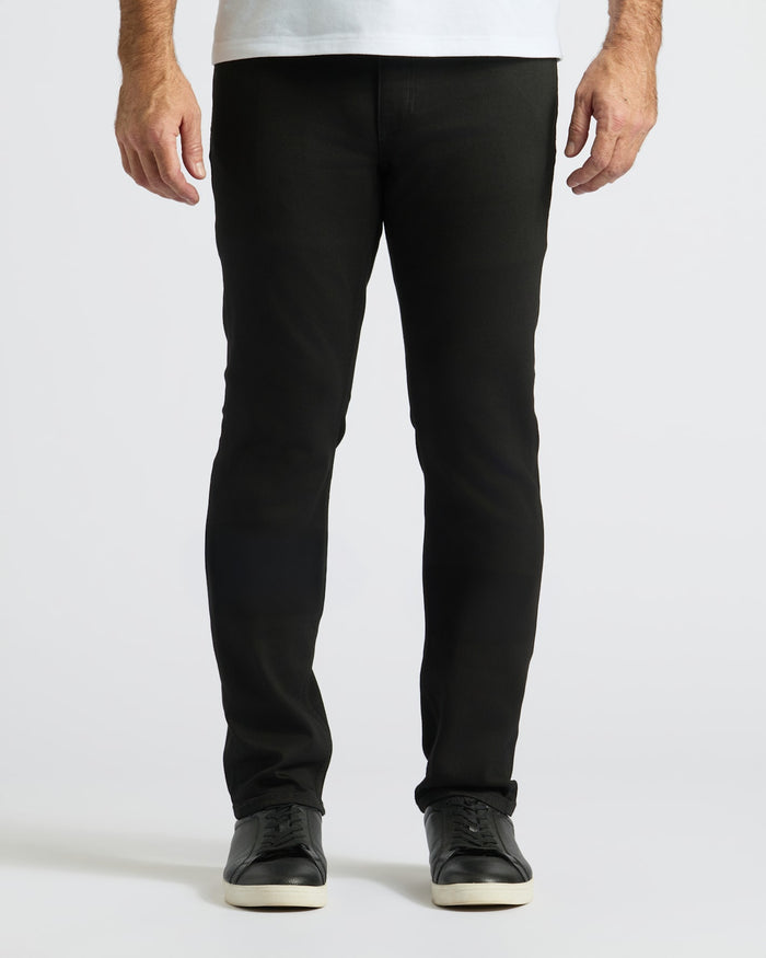 Black Wash Straight Comfort Stretch Jeans with black sneakers.