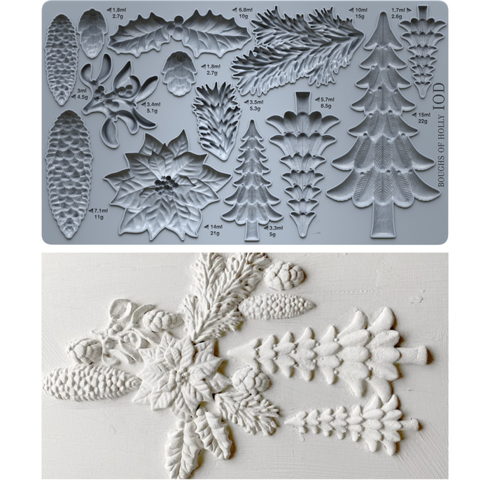 A mold tray with embossed Christmas tree, pinecone, holly, and floral shapes, shown above a white textured surface with the corresponding white embossed decorations.