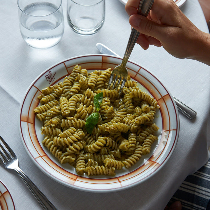 A turquoise bag of ATALANTA CORPORATION CIPRIANI - ORGANIC DURUM WHEAT FUSILLI stands upright on a white background, with the high protein pasta made using a traditional copper die visible through a clear window on the front.