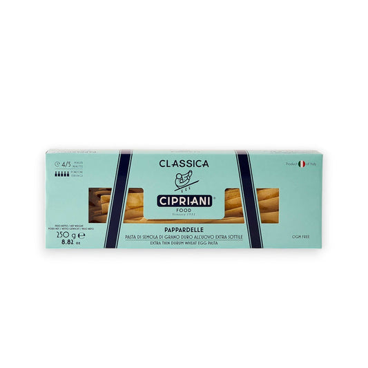 A rectangular box of Cipriani Organic Egg Pappardelle Pasta, produced by Atalanta Corporation and made in Italy, is displayed against a pale background. The light blue packaging with dark blue and white accents features branding details, cooking information, and a small Italian flag denoting its origin.
