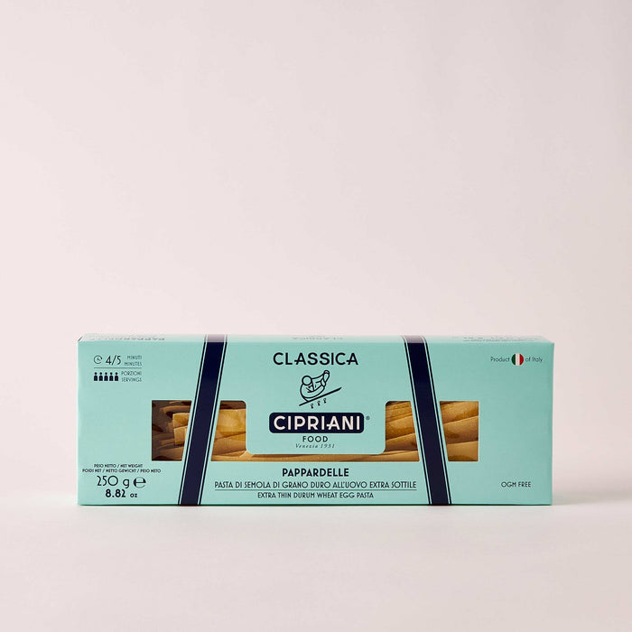 A light blue box of ATALANTA CORPORATION CIPRIANI - ORGANIC EGG PAPARDELLE PASTA shows the pasta through a clear window, with Italian text, a small Italian flag on the right, and "Made in Italy" proudly displayed.