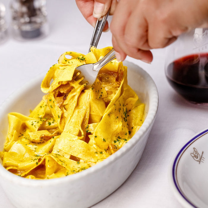 A light blue box of ATALANTA CORPORATION CIPRIANI - ORGANIC EGG PAPARDELLE PASTA shows the pasta through a clear window, with Italian text, a small Italian flag on the right, and "Made in Italy" proudly displayed.