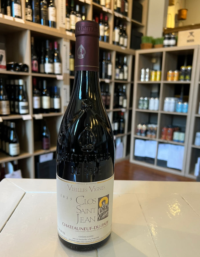 A bottle of CLOS SAINT JEAN 'VIEILLES VIGNES' CHÂTEAUNEUF-DU-PAPE 2023 by WINE: A-VIN-GARDE/BORDEAUX FINE & RARE, featuring a maroon foil capsule and a cream label with gold and black text plus a small illustration.