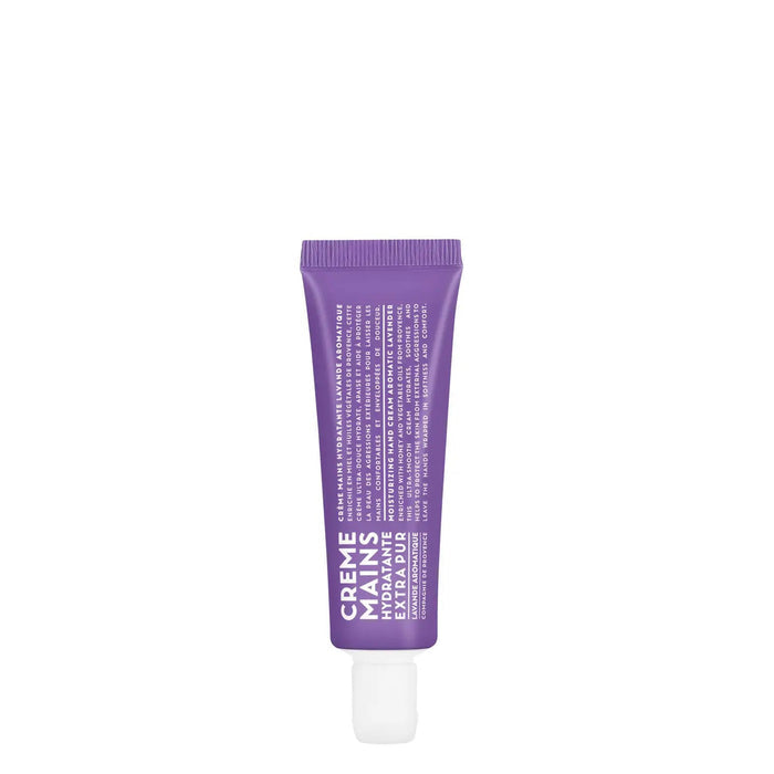 A purple tube of CIE LUXE BRANDS' COMPAGNIE DE PROVENCE TRAVEL HAND CREAM AROMATIC LAVENDER 1OZ stands upright, featuring "Creme Mains" and details about botanical oils in white text on a white background.