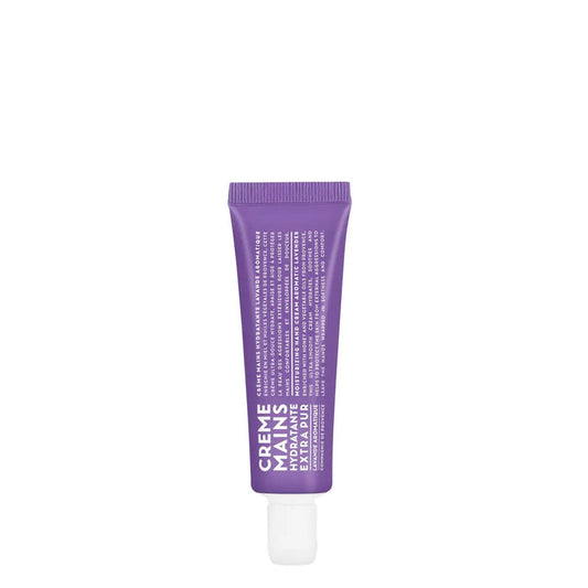 A purple tube of CIE LUXE BRANDS' COMPAGNIE DE PROVENCE TRAVEL HAND CREAM AROMATIC LAVENDER 1OZ stands upright, featuring "Creme Mains" and details about botanical oils in white text on a white background.
