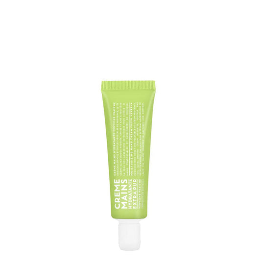 A 1oz green tube of COMPAGNIE DE PROVENCE TRAVEL HAND CREAM FRESH VERBENA by CIE LUXE BRANDS, labeled "Crème Mains Hydratante Extra Pure" in white, with botanical oils, stands upright on a white background.