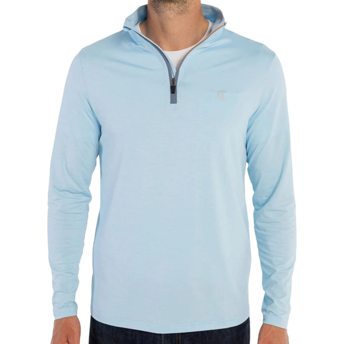 A man wears the CRIQUET Feather Performance Knit Quarter Zip Pullover in Heather Blue, featuring brrr° technology and a small embroidered logo on the chest, over a white T-shirt. His face is partially out of frame.
