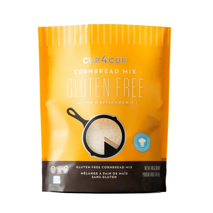 A yellow package of CUP4CUP GLUTEN FREE CORNBREAD by CUP4CUP shows a skillet with cornbread, states it's gluten free and dairy-free cornbread, and features a blue chef’s hat icon in the bottom right corner.