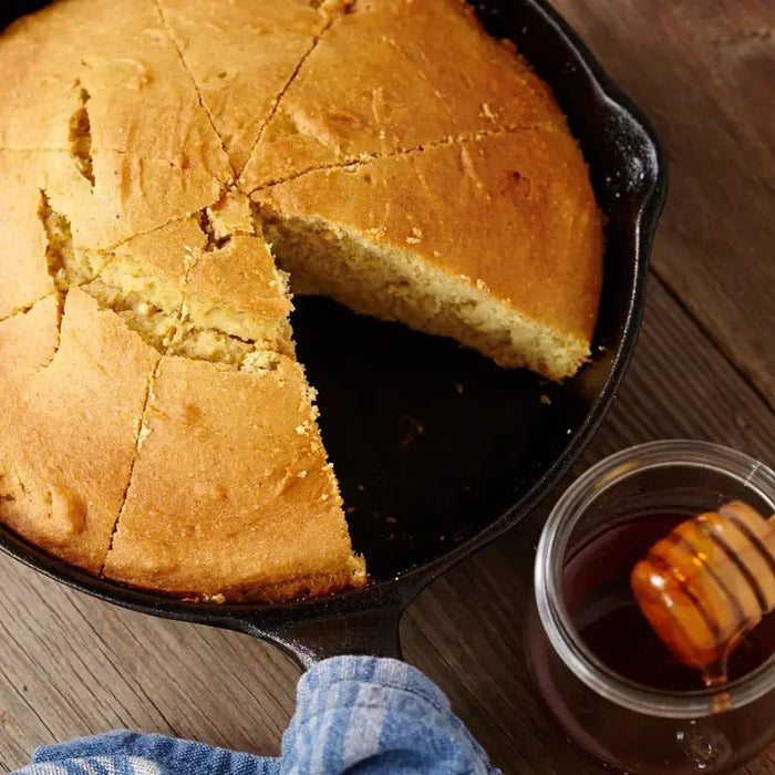A yellow package of CUP4CUP GLUTEN FREE CORNBREAD by CUP4CUP shows a skillet with cornbread, states it's gluten free and dairy-free cornbread, and features a blue chef’s hat icon in the bottom right corner.
