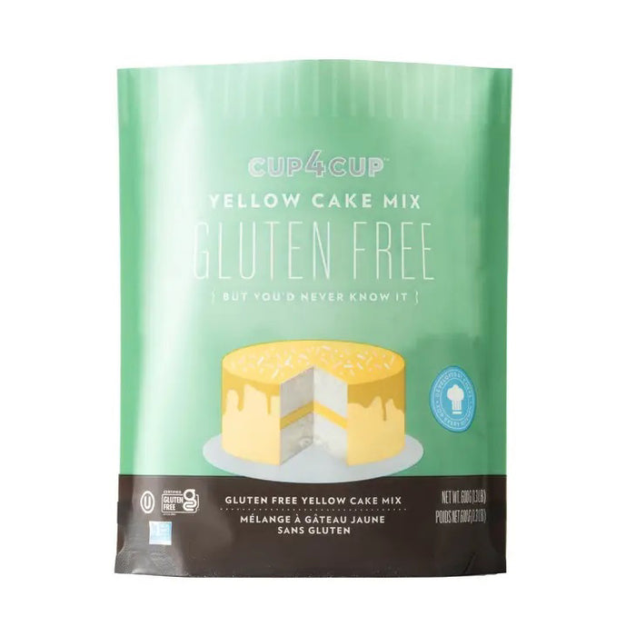 A green and brown package of CUP4CUP GLUTEN FREE YELLOW CAKE MIX by CUP4CUP, labeled "Gluten Free," features an illustration of a yellow layer cake with white frosting and a slice cut out. Perfect for premium baking.