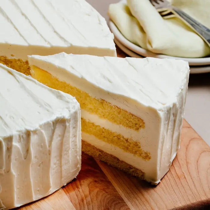 A green and brown package of CUP4CUP GLUTEN FREE YELLOW CAKE MIX by CUP4CUP, labeled "Gluten Free," features an illustration of a yellow layer cake with white frosting and a slice cut out. Perfect for premium baking.