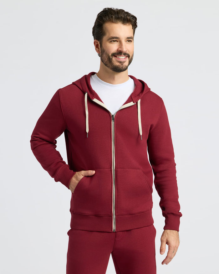 Man wearing Dark Maroon Fleece French Terry Zip Hoodie, smiling.