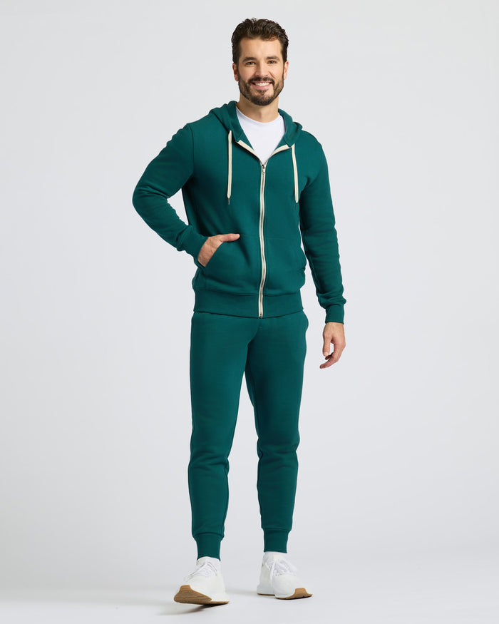Man in Deep Emerald Fleece French Terry Zip Hoodie, smiling.