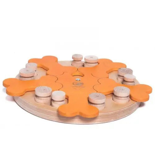 The DOG PUZZLE - CAROUSEL OF BONES by MY INTELLIGENT PETS is a round wooden interactive dog toy featuring orange bone-shaped pieces and pegs that pets move to uncover hidden treats.