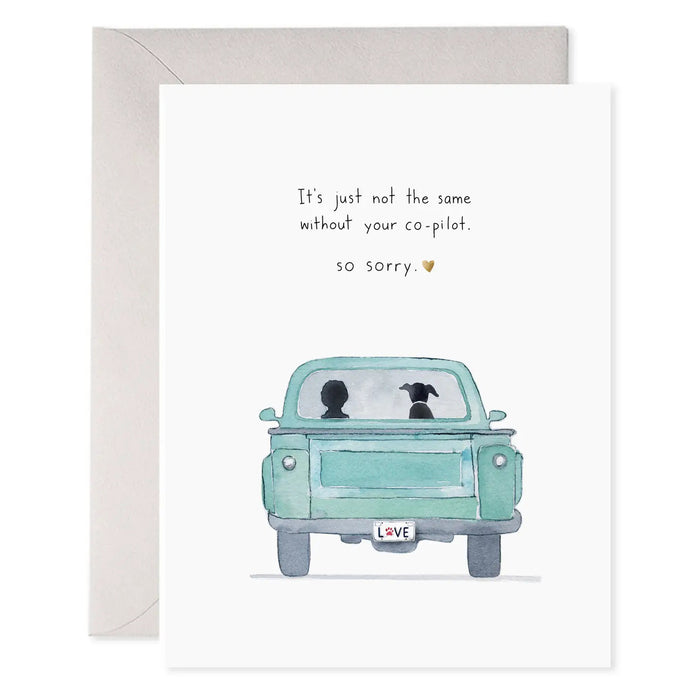 The E. FRANCES - CO PILOT DOG CARD by E. FRANCES PAPER features a watercolor person and dog in a blue truck, with gold foil, "LOVE" license plate, and the message: "It's just not the same without your co-pilot. so sorry.