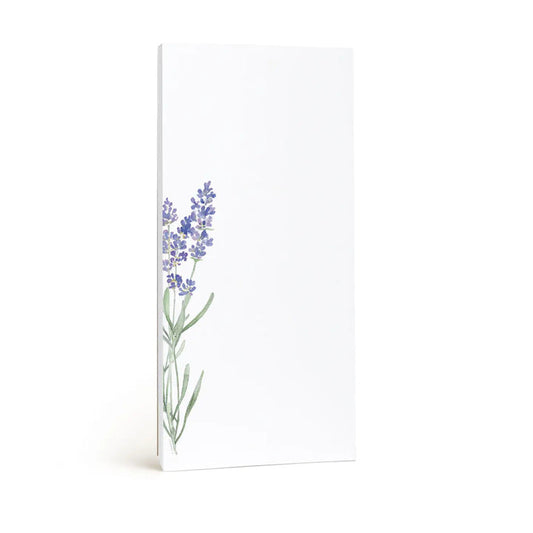 The E. FRANCES - LAVENDER MARKET NOTEPAD by E. FRANCES PAPER is a tall, rectangular white notepad made in the USA, featuring a watercolor illustration of purple lavender with green stems in the bottom left corner. The rest is blank.