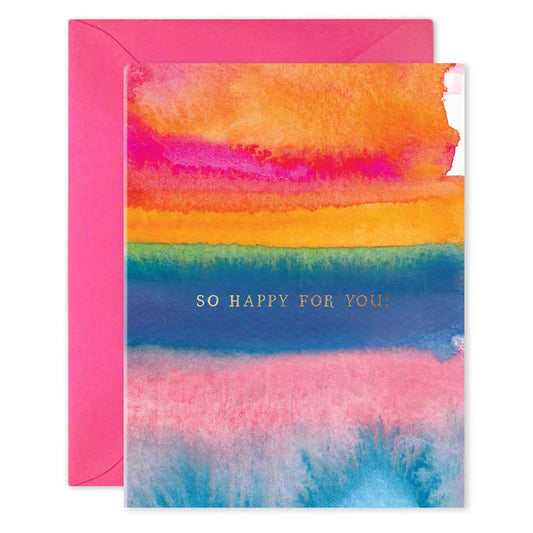 The E. FRANCES - SO HAPPY FOR YOU CARD by E. FRANCES PAPER features a colorful watercolor design and gold foil "SO HAPPY FOR YOU!" text, paired with a bright pink envelope for a cheerful touch.