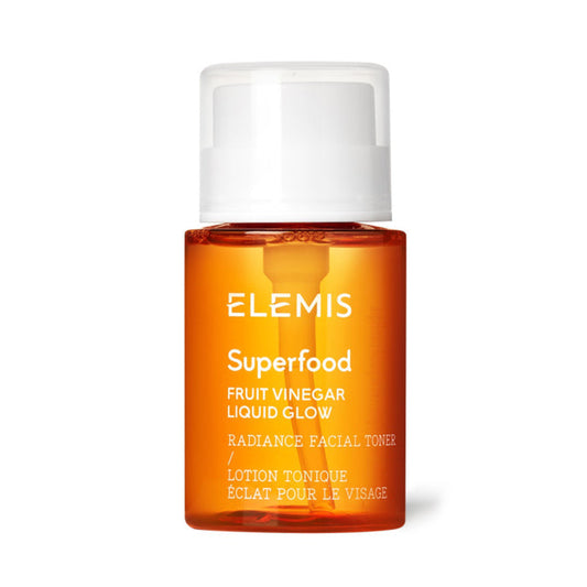 A bottle of ELEMIS - SUPERFOOD FRUIT VINEGAR LIQUID GLOW by ELEMIS - STEINER featuring an orange body, white pump cap, and white text—an AHA exfoliating facial toner for glowing, radiant skin.