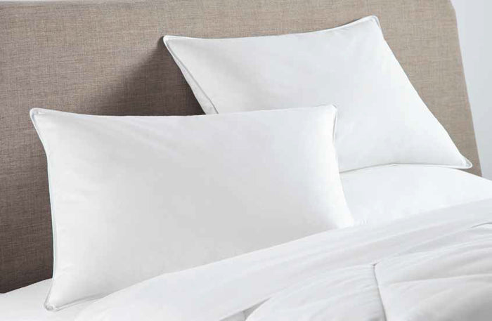 Two DOWNLITE FEARRINGTON LIFESTYLE BEDDING COLLECTION standard feather pillows are stacked against a plain white background.