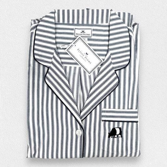 The folded FEARRINGTON LIFESTYLE COLLECTION - MENS TWILL NAVY FRENCH TICKING PAJAMAS by PETITE PLUME features luxury cotton sleepwear in white with navy stripes, a chest pocket with embroidered sheep, and a “Petite Plume” tag on the collar.