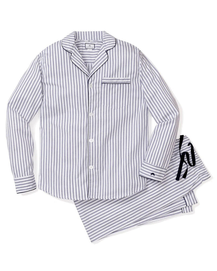 The folded FEARRINGTON LIFESTYLE COLLECTION - MENS TWILL NAVY FRENCH TICKING PAJAMAS by PETITE PLUME features luxury cotton sleepwear in white with navy stripes, a chest pocket with embroidered sheep, and a “Petite Plume” tag on the collar.