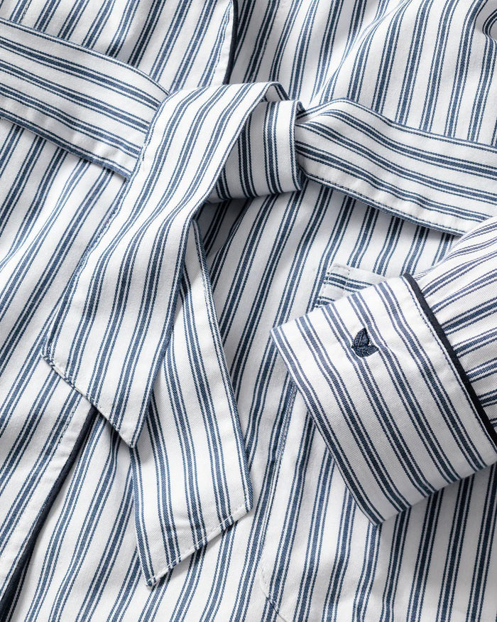 The PETITE PLUME FEARRINGTON LIFESTYLE COLLECTION Women's Twill Robe in Navy French Ticking features long sleeves, a knee-length cut, belt, and front pockets—ideal for pairing with luxury cotton sleepwear.