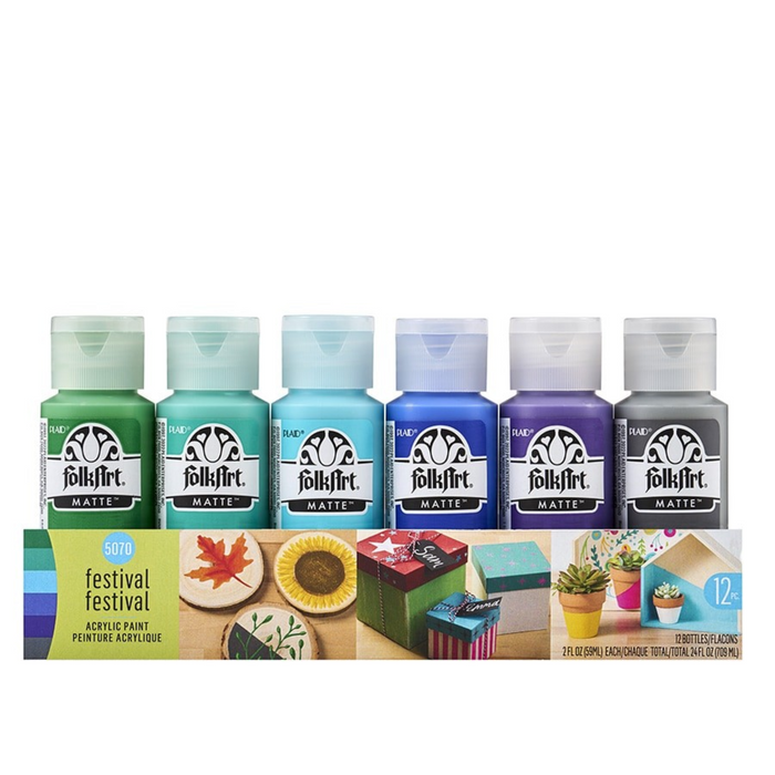Set of FolkArt acrylic paint bottles with a display of painted projects on a white background