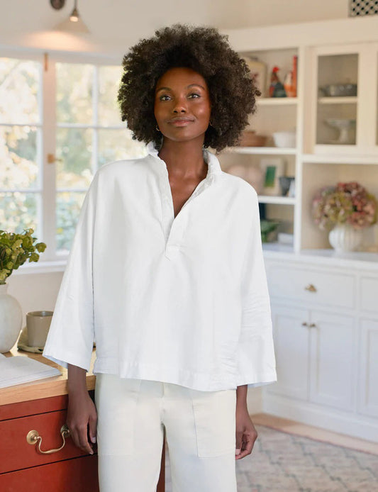 The FRANK & EILEEN Gabi Popover Shirt in Famous Denim White features a loose fit, long sleeves, a deep V neckline, and a collared design—ideal for layering over your favorite denim looks.