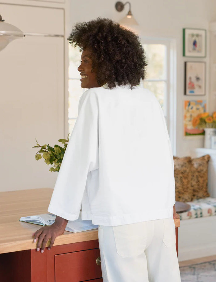 The FRANK & EILEEN Gabi Popover Shirt in Famous Denim White features a loose fit, long sleeves, a deep V neckline, and a collared design—ideal for layering over your favorite denim looks.