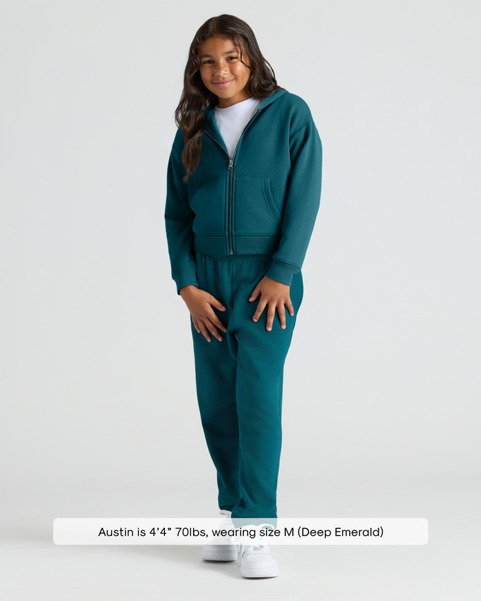 Child in Girls Deep Emerald Cropped Zip Hoodie & Relaxed Joggers.