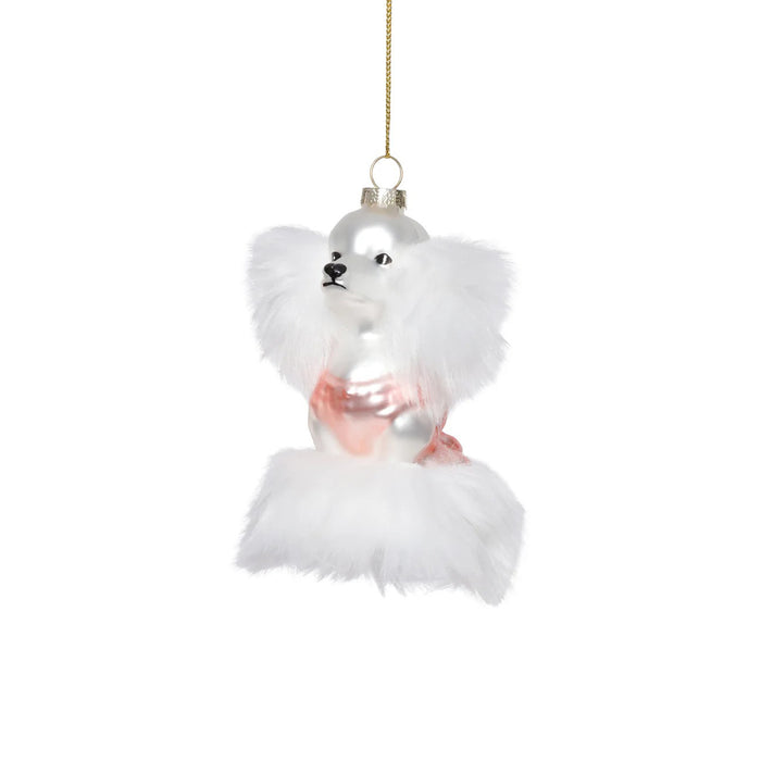 The ZODAX GLASS STANDARD POODLE ORNAMENT features a white poodle with fluffy fur and a pink outfit, hanging from a gold string. Sized 3" x 2" x 4.5", it fits perfectly in a small box—ideal for festive decor or gifting.