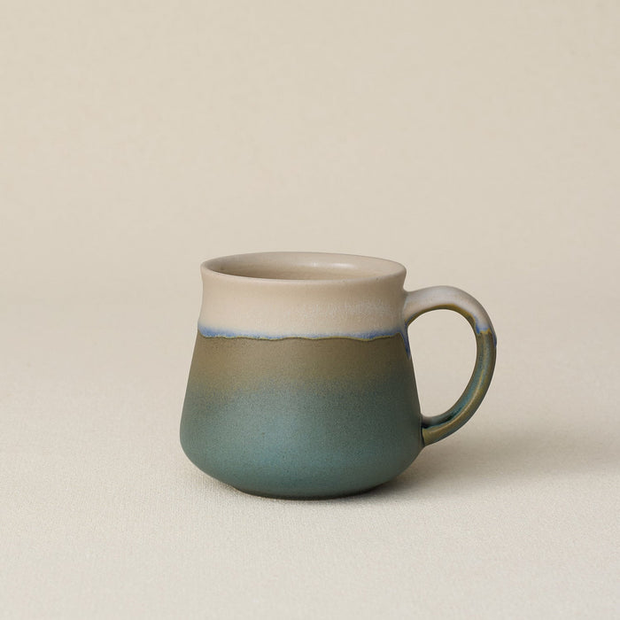 Hand-thrown ceramic mug by Rookwood Pottery