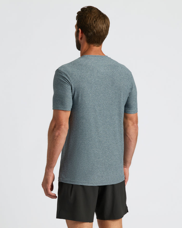 Man wearing Heather Navy Active Crew Neck Tee and black shorts, back view.
