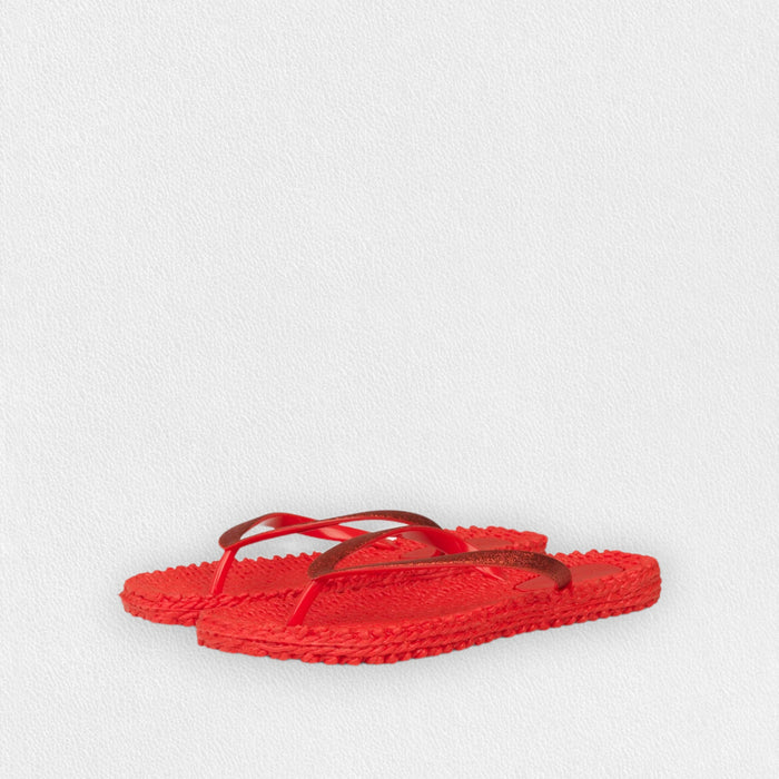 The ILSE JACOBSEN CHEERFUL FLIP FLOP IN DEEP RED by LINES OF DENMARK features woven design and thin dark red straps—perfect lightweight sandals for beach comfort, displayed on a light textured background.